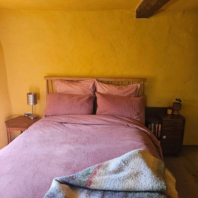 I refused to decorate my home for guests or potential buyers, and painted my lime-plastered spare bedroom bright yellow – and I couldn't be happier
