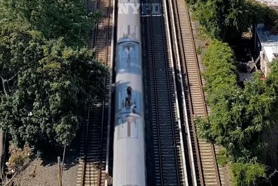 Teenage subway surfers filmed running along top of cars are tracked down by NYPD drones