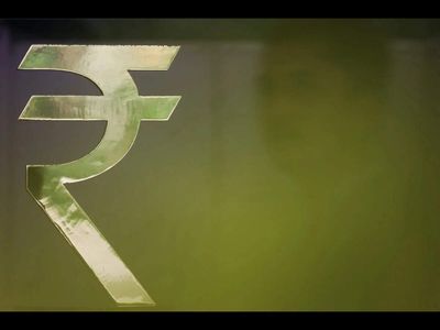 Rupee clings to two-week high as oil slides, intervention helps cement rise