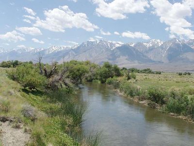 In 1913, Los Angeles began diverting Owens River water, helping dry Owens Lake into a dust-blowing salt flat; controls now cut dust by up to 99% in treated areas