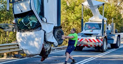 Man rescued after car towing caravan drives off highway bridge