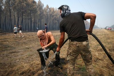 Rain dampens major fire in France