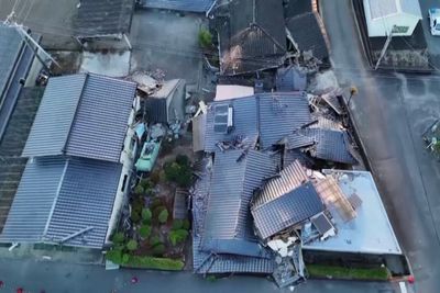Days after Japan's quake, a family shelters in their car in sweltering heat