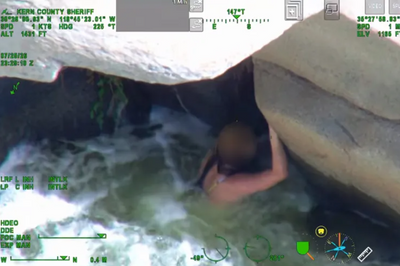 California woman was swept down the Kern River and found clinging beneath a rock; rescuers pulled her from the rapids