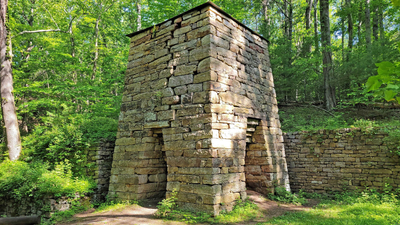 Virginia's iron furnaces burned an acre of forest a day for just five tons of metal; today, 10 stone ruins hide across 1.8 million forested acres