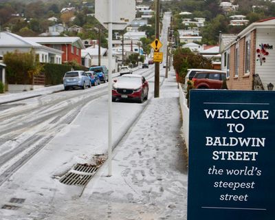 New Zealand capital delights in rare snowfall as southern city residents ski down world’s steepest street