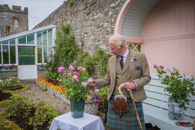 King plants royal rose as he begins summer break in Scotland