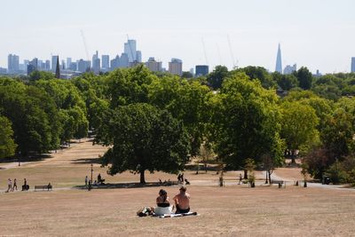 Temperatures rise above 30C while Scotland hit by half month’s rain in two days