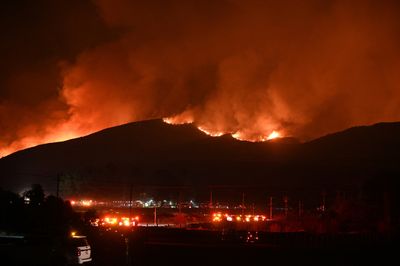 Wildfires Kill Two, Force More Than 100,000 to Flee Homes Across Western U.S. and Canada