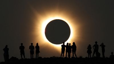 Millions gather to watch as solar eclipse plunges swathe of Spain into darkness