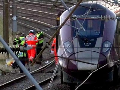 Passenger train derails and 11 people injured after carriages overturn in southern England