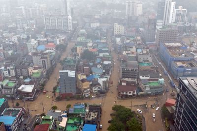 Heavy rains kill 1 in South Korea and flood major streets in Philippines