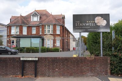 Somali small boat migrant 'slashed welfare officer with knife' at asylum hotel on edge of London