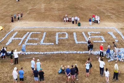 Angry villagers spell out ‘help us’ with plastic bottles after going days without water