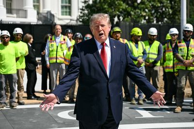 Trump unveils latest construction obsession with hardhat tour of White House helipad: ‘Real artists’