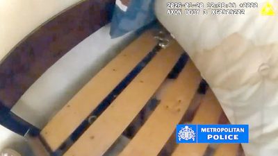 Moment police find woman who plotted brutal knife attack on partner hiding under bed