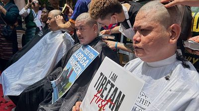 Tibetan protesters in New Dehli denounce China with shaved heads and prayers