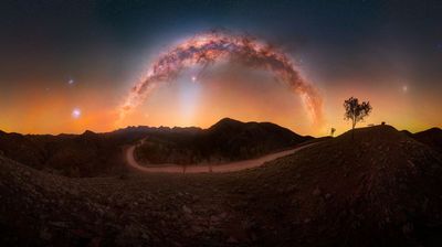 This majestic Milky Way photograph “celebrates the remarkable clarity of Australia’s dark skies, where multiple celestial phenomena can be experienced together above an iconic outback landscape”