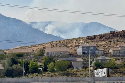 Firefighters are trying to stop a fast-moving Nevada wildfire from spreading to homes in Reno