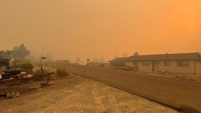Nevada wildfire forces tens of thousands to evacuate as blaze threatens city of Reno