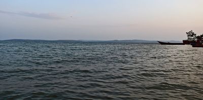 Sunscreen for lakes and dams: could a thin floating layer of nanomaterial shield water from evaporation?