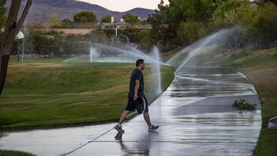 Las Vegas Valley converted 250 million sq ft of lawn to save water, saving 203 billion gallons; researchers found turf removal can raise summer land-surface temperatures about 20°C