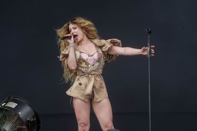 Slayyyter makes UK debut performing to poncho-wearing crowd at Reading festival