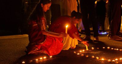 'Standing together': community mourns flood victims with candles of hope