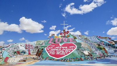A California man spent nearly 30 years hand-building Salvation Mountain from adobe, straw and thousands of gallons of paint; Leonard Knight’s landmark rises near Niland