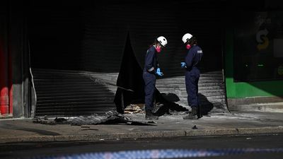 Manhunt as tobacco shop arsonist 'left for dead'
