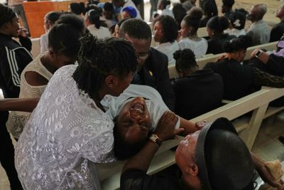 Mourners file into a church in Haiti where gangs killed dozens of people in latest rampage