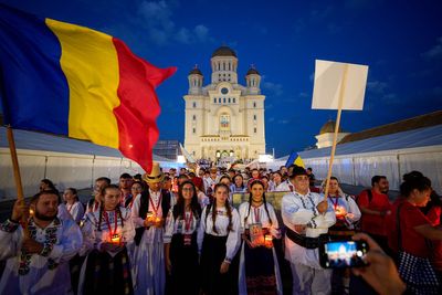 Young Orthodox Christians take part in a lights procession in Romania’s capital