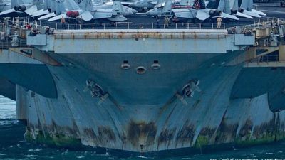 Rust streaks, faded paint and 5,000 tired sailors: War-weary USS Lincoln docks in Thailand