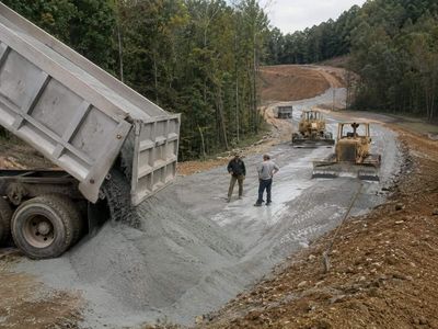 In 1989, Kentucky engineers built a 750-foot road base using about 80 tons of ponded fly ash; the 11% ash section was reported to perform well against the conventional control