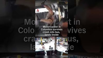 Watch a Motorcyclist Crash Into an Open City Bus Door and Catch a Ride