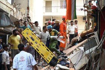 Building collapse in New Delhi kills 1 and traps others