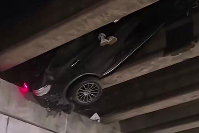 How did this happen?! Viral video shows a car stuck under highway overpass 20 feet in the air