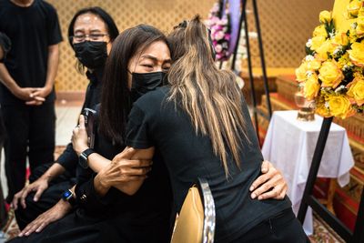 Thai police officer who allegedly gunned down his wife at kindergarten surrenders after 18-hour standoff