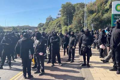 Police urged to take robust action against anti-migrant demonstrators wearing balaclavas