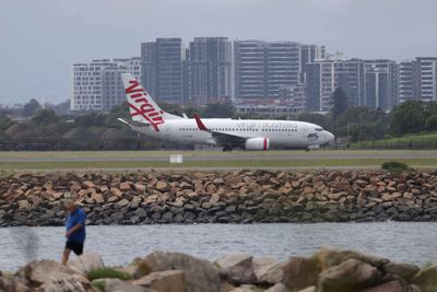 Sydney Airport hit by flight delays, cancellations as air traffic controller shortage bites