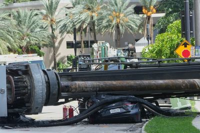 Four hospitalized after crane collapsed on moving car from Miami construction site, causing a fire