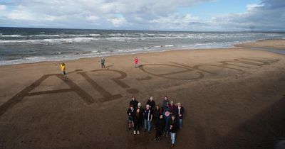 Campaigners draw giant anti-AI message on Scottish beach ahead of key vote
