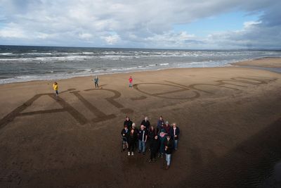 Activists write ‘naw’ to AI on beach as execs set to fly in for summit with King