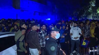 Police fire shots in the air as thousands of migrants moved to new facility in Ceuta