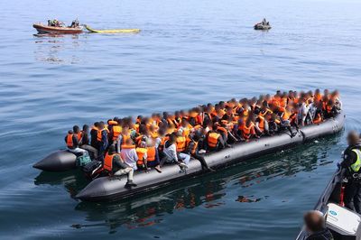 Footage captures teenager steering dinghy carrying 165 people across Channel