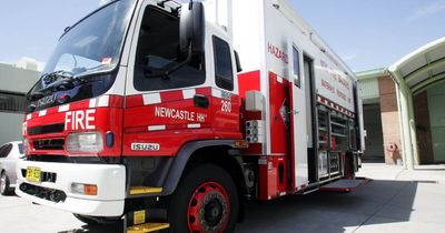 Workers evacuated and road closed as grass fire burns in industrial suburb