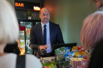 Prince William quizzed over Diana book as he visits cinema to serve popcorn