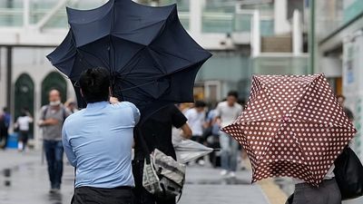 Flooded streets and rescues as Typhoon Dujuan hits Japan