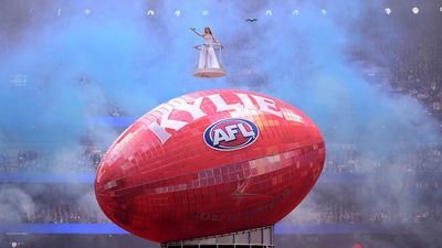 'So lucky': Kylie lights up rain-soaked AFL grand final