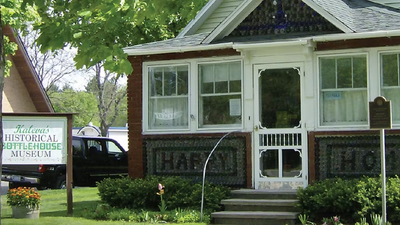 In 1941, John Makinen built a Michigan bottle house from 60,000 flawed bottles; a museum bought it in 1983